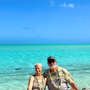 Friendly stingrays swimming in shallow lagoon waters of Bora Bora