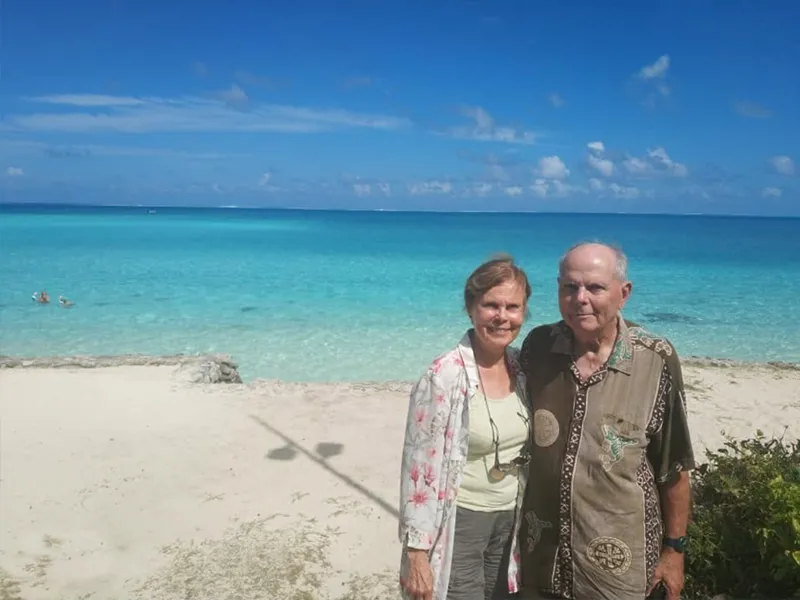 White sand shoreline of Matira Beach with crystal clear turquoise water for snorkeling in Bora Bora